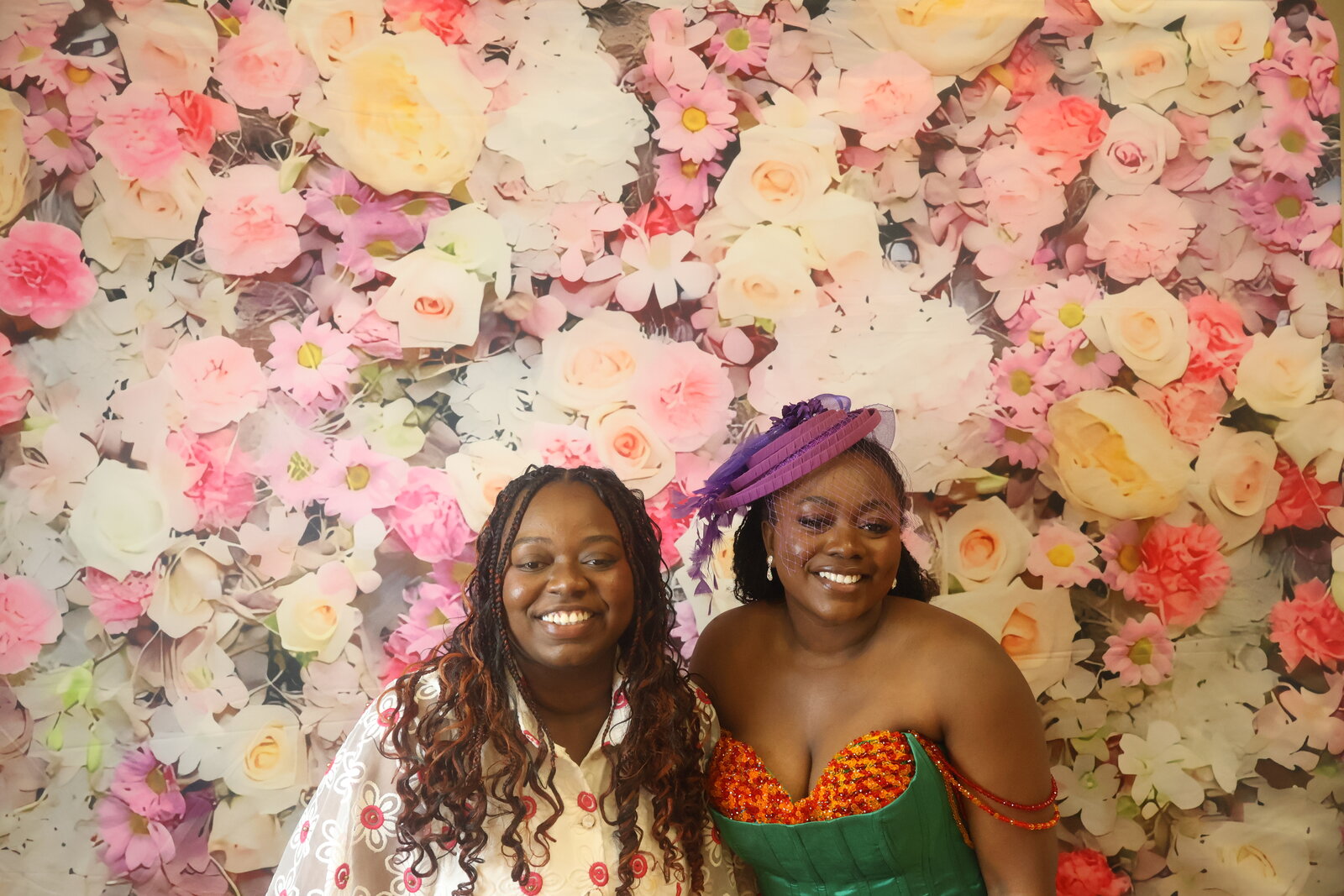 Calgary celebration guests posing at the floral photo booth backdrop