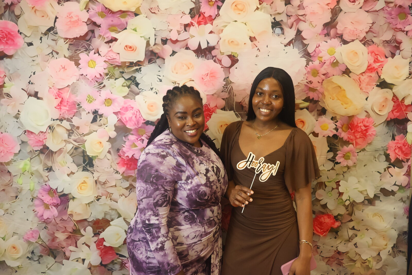 Calgary celebration guests with Hooray prop at the floral photo booth backdrop